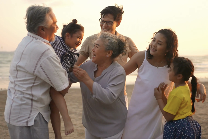 Happy multi-generational family on a beach.