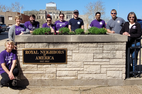Photo of Royal Neighbors employees outside by Royal Neighbors sign